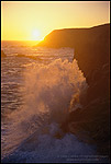 Photo: Wave crashing on coastal rocks at sunset, Marin Headlands, California