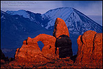 Photo: Sunset light on Turret Arch and the LaSal Mountains during a storm as seen from Arches National Park, Utah