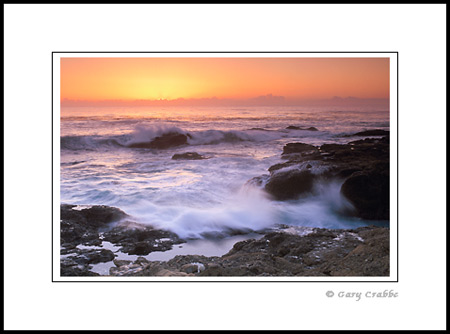Ocean waves crashing on rocks at sunset, Point Lobos State Reserve, near Carmel, Monterey County Coast, California