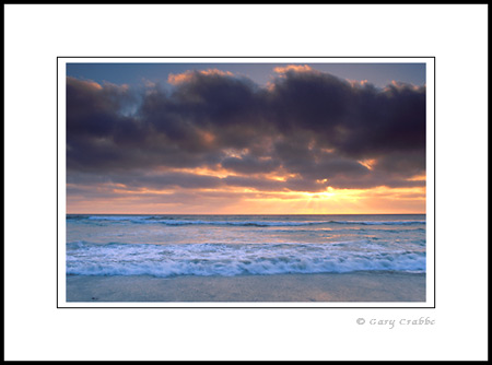 Coastal fog at sunset over waves on beach, Torrey Pines State Beach, near La Jolla, San Diego County Coast, California