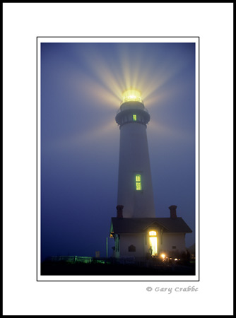 Light beams from Fresnel Lens in evening fog, Pigeon Point Lighthouse, near Pescadero, San Mateo Coast, California