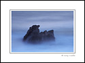 Rock and moving ocean waves in evening light, Sonoma Coast, California
