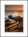 Wooden stairway leading to rocks and ocean at sunset, Cambria, Central Coast, California