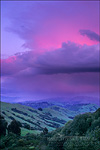 picture: Alpenglow on storm cloud at sunset over green hills near Orinda, Contra Costa County, California