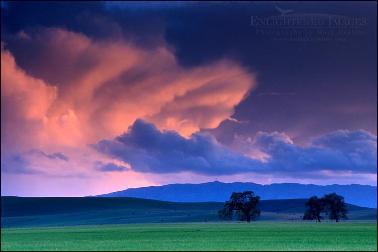 picture: Red sunset sky thunderstorm storm cloud cumulonimbus stratus clouds over green lush farm pasture field Tassajara California