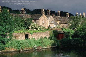 Morning light on stone houses along the Wye River at Bakewell, Peak District National Park, England 