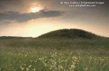 Sunset over ancient burial mound near Stonehenge, Salsbury Plain, England