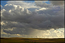 Picture: Storm clouds over wind turbines in wind farm at Solano County, California