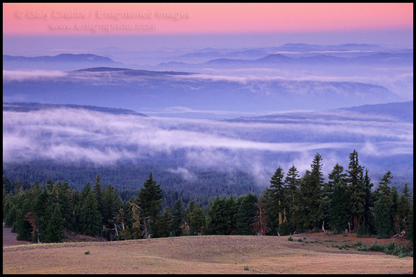 Photo: Morning light and misty clouds over trees, forest, and hills, Crater Lake National Park, Oregon