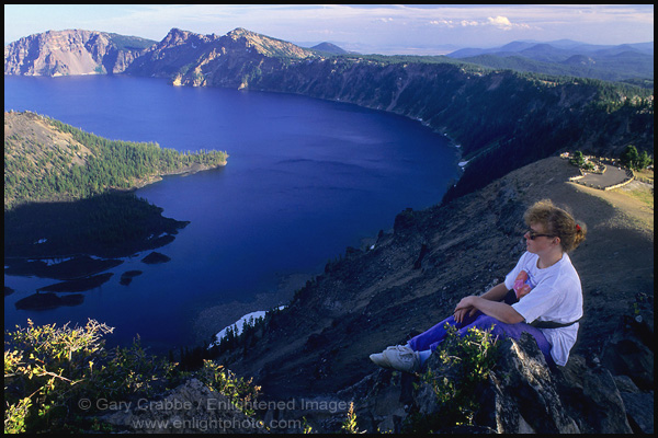 Photo: Tourist overlooking Crater Lake from high on the rim near The Watchman, Crater Lake National Park, Oregon