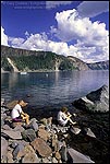 Picture: Tourists relaxing on the rocky shoreline at Cleetwood Cove, Crater Lake National Park, Oregon