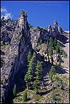 Picture: Steep rugged jagged rocky volcanic crater wall, Crater Lake National Park, Oregon