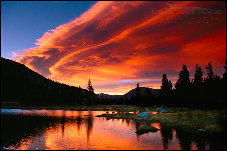 Picture: Alpenglow on lenticular cloud at sunset over alpine tarn at Tioga Pass, Yosemite National Park, California