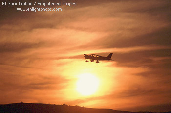 Small plane  flying at sunset over Contra Costa County, California