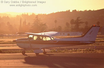Cessna on taxiway at sunset, Buchanan Fields Contra Costa Co., California