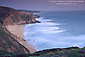 Evening light over breaking waves at Grey Whale Cove State Beach, San Mateo Coast, California