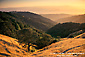 Golden sunset over oak and grass covered hills along Palassou Ridge, above Morgan Hill, Santa Clara County, California