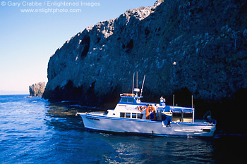 Photo: Island Packers boat in cove below cliff of East Anacapa Island, Channel Islands National Park, Southern California Coast