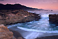 Eveni ng wave rolls into coastal cove, Point Lobos State Reserve, near Carmel, California