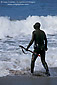 Spear fishing diver in wetsuit enters ocean water waves at Point Dume State Beach near Malibu, Los Angeles County, California