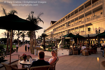 Couple relaxing on patio at sunset, Hotel Del Coronado resort, Coronado Island, San Diego, California