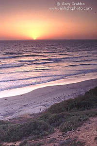 Sunset over the Pacific Ocean and the beach at Carlsbad, San Diego County, California