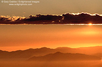 Sunburst through cloud layer over San Francisco Bay and Angel Island, from the Berkeley Hills, California