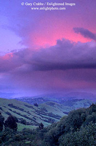 Alpenglow on thundercloud at sunset over the Orinda Hills in spring, Contra Costa County, California