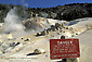 Danger sign warning tourists not to walk on fragile volcanic ground crust at Bumpass Hell, Lassen Volcanic National Park, California