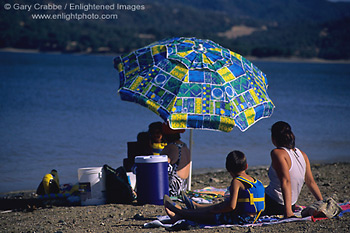 Family on Beach with shade umbrella, Lake Mendocino, Mendocino County, California