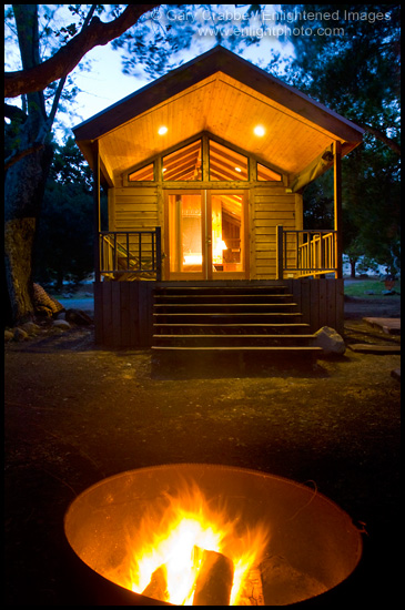 Photo: Evening campfire in fire pit in front of rustic wood cabin, El Capitan Canyon Resort, near Santa Barbara, California