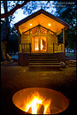 Picture: Evening campfire in fire pit in front of rustic wood cabin, El Capitan Canyon Resort, near Santa Barbara, California