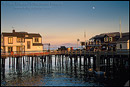 Picture: Moonrise at sunset over buildings on Stearns Wharf, Santa Barbara, California