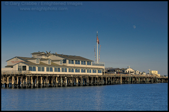 Moon rising over shops and restaurants at Stearns Wharf, Santa Barbara, Southern Coast, California