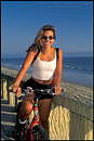 Picture: Pretty Woman relaxes next to ocean during bike ride, Butterfly Beach, Santa Barbara, California