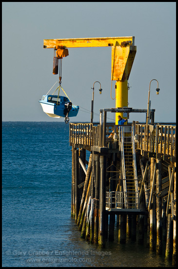 Launching a small motor boat from pier at Gaviota Beach State Park, near Santa Barbara, California 