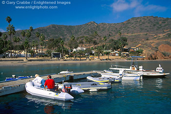 Picture: Couple in raft pull up to dock at Two Harbors, Catalina Island, California