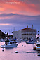 Picture: Red clouds at sunset over the Casino Building and boats in Avalon Harbor, Avalon, Catalina Island, California
