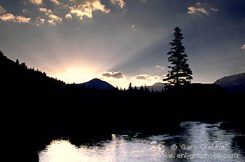 Sunrise beams over mountains and alpine stream, Tuolumne Meadows region, Yosemite National Park, California