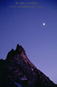 Crescent moon in evening light over Ragged Peak mountain, Yosemite National Park, California