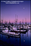 Picture: Moonset at dawn over commercial fishing boats in harbor docks, Crescent City, California