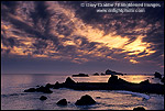 Photo: Sunset and clouds over coastal rocks and ocean at Cresent City, California