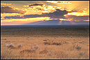 Picture: Golden sunbeams through clouds at sunset over the High Desert of Southern Colorado