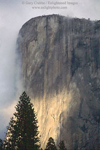 Sunlight through storm clouds on the base of El Capitan, Yosemite National Park, California