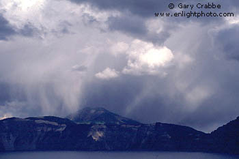 Rain and sunlight in a fall storm over Crater Lake, Crater Lake National Park, Oregon