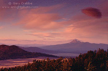 Red sky at sunset over Mount Thielsen and grass covered mountain valley, from rim of Crater Lake, Crater Lake National Park, Oregon