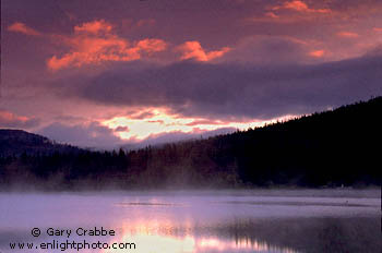 Red clouds at sunrise in stormy sky over Trillium Lake, Mount Hood National Recreation Area, Oregon