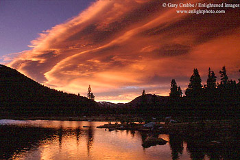 Lenticular cloud at sunset over alpint tarn near Tioga Pass, Yosemite National Park, California