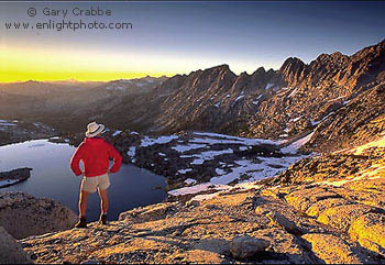 Hiker at sunset on 11,000 foot mountain pass, Hoover Wilderness, Yosemite National Park, California