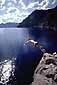 Cliff diving into the clear blue water of Crater Lake, Crater Lake National Park, Oregon
